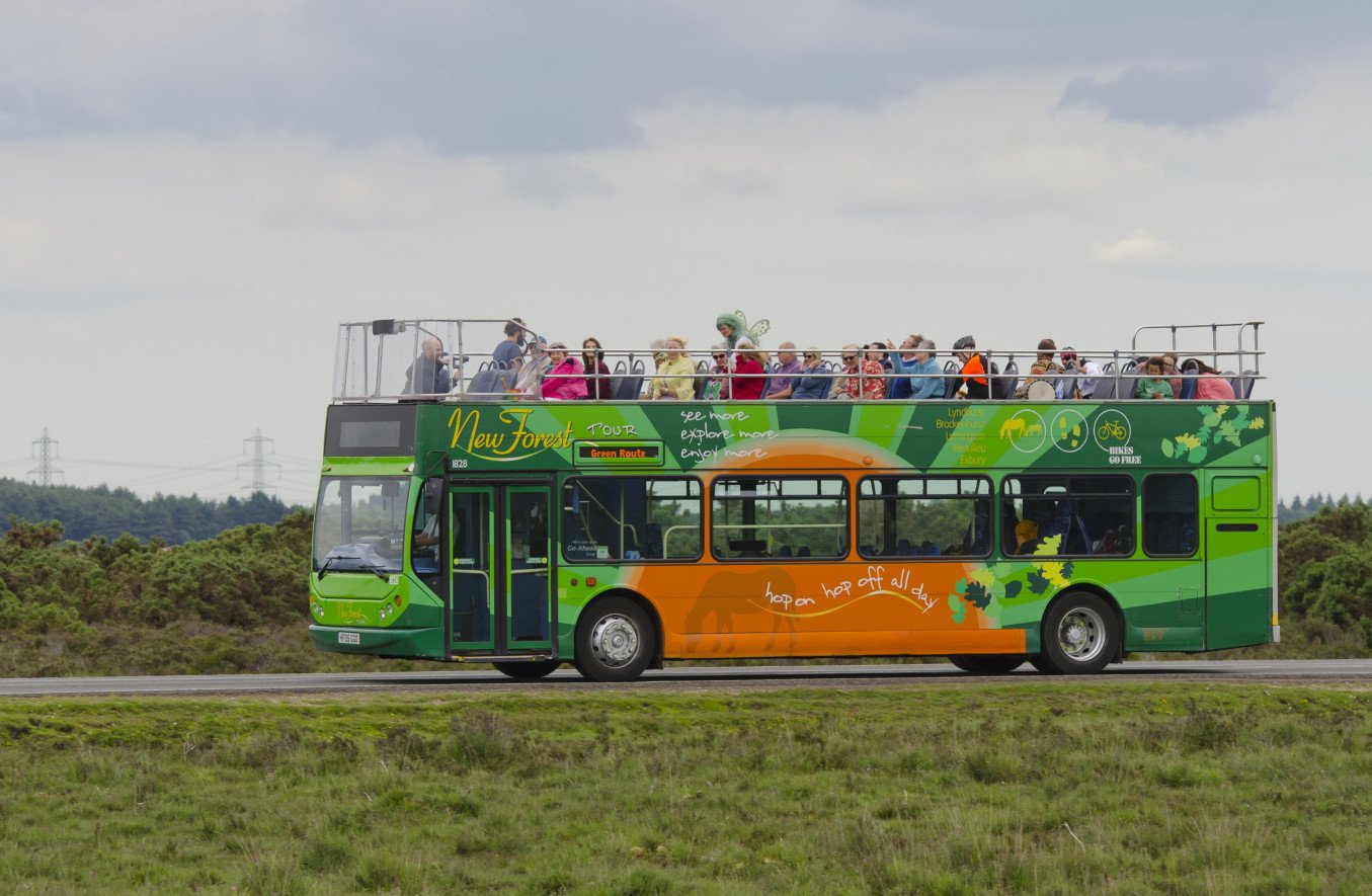 A packed New Forest Tour bus on the road